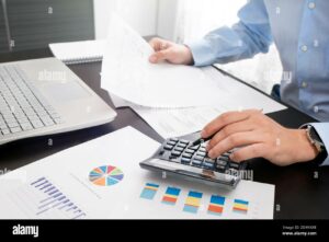 Accountant at work in the office Man calculates income and expenses