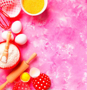 Baking Background Food Ingredients For Baking Flour Eggs Sugar On Pink