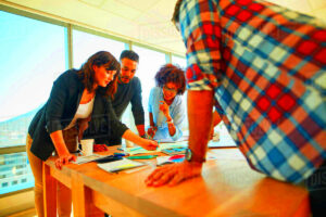 Team of creative professionals working together in office Group of