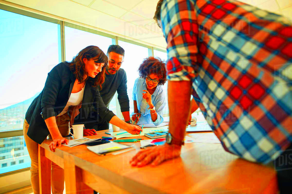 Team of creative professionals working together in office Group of